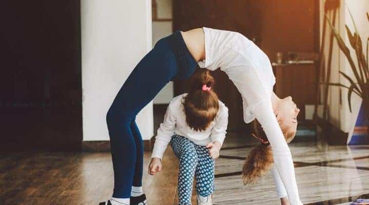 Mom and daughter doing yoga together family fitness