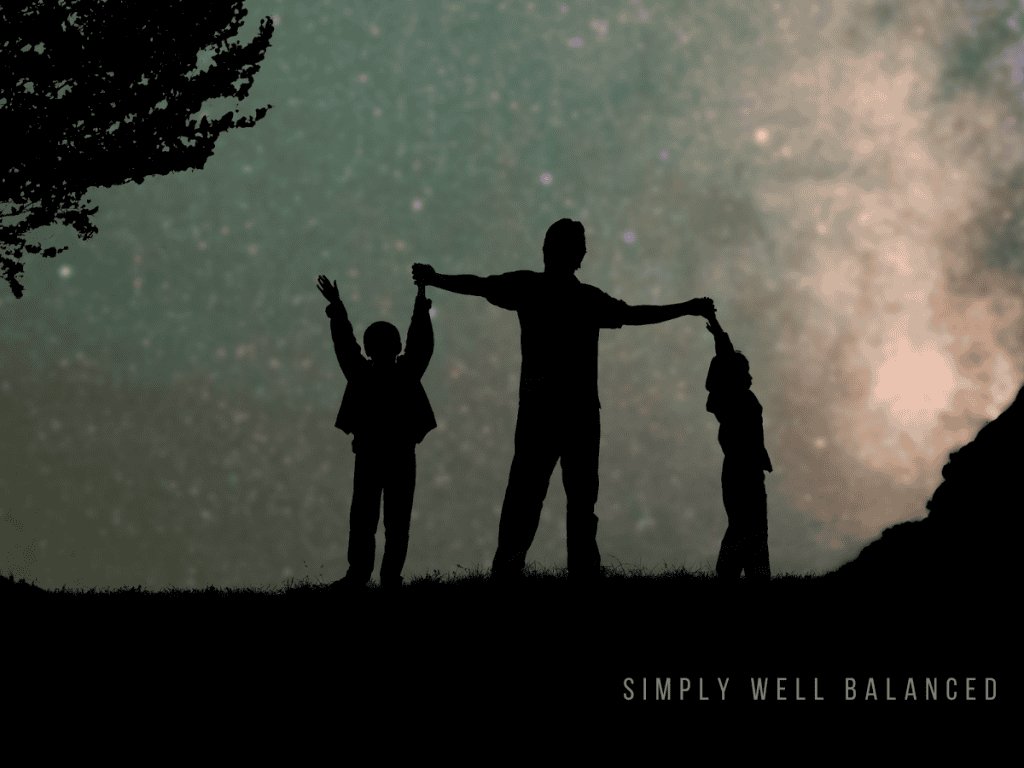 Family silhouetted under a starry night sky during an outdoor evening activity with kids