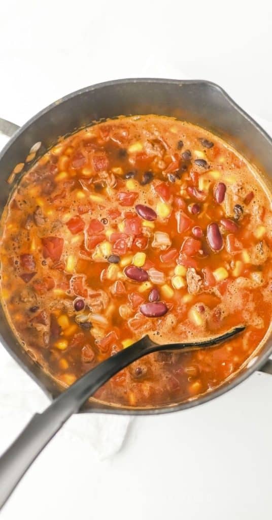 Easy Taco Soup Simmering in a pot on the stove.