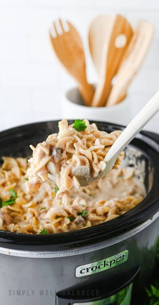 A scoop of creamy crockpot beef stroganoff ready to serve.