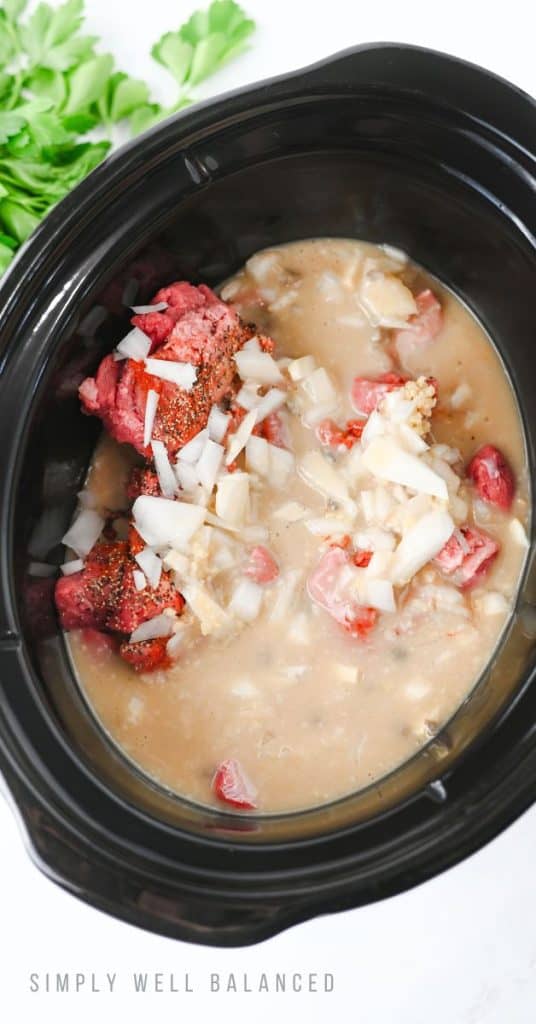 Slow Cooker Beef Stroganoff Recipe Step 3: The sauce has been poured over the previous ingredients. Ready to put the lid on the crock pot.